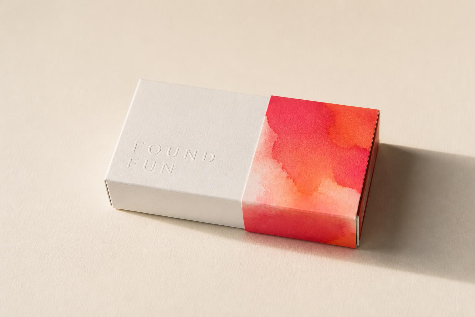 FOUND chaser candy box — white debossed wordmark with a coral watercolor sleeve.